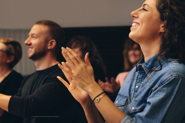 Business people clapping hands during a conference. Business professionals applauding at a seminar.